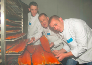 Fishy business: Fintan, Liam and Ronan Quinlan bust at work at their salmon smokery. Picture: Don MacMonagle